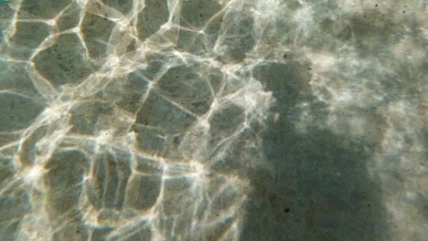 abstract reflective shapes of water ripples on pool floor - ultra slow motion