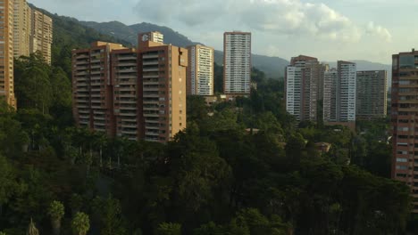 backwards flight reveals residential homes in medellin, colombia