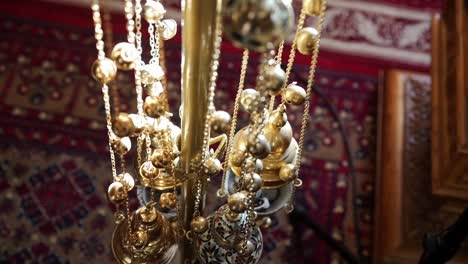 ornate censer hangs in church with intricate patterns