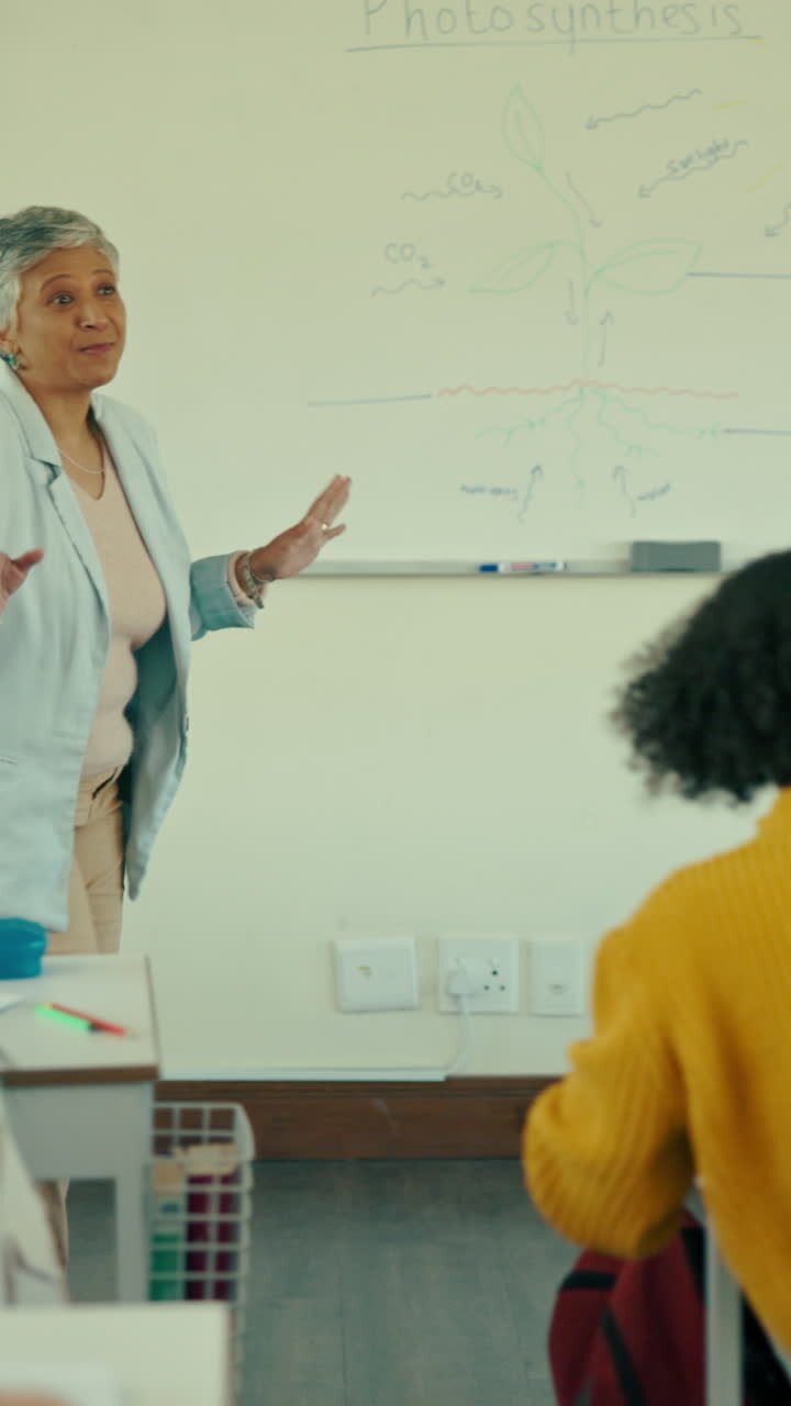 Mature Teacher Explaining Plant Biology to Students in Classroom