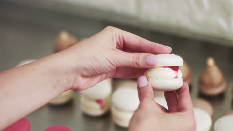 woman holding a delicious white macaron