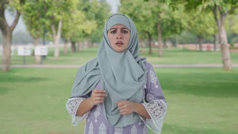 muslim woman getting a shocking news in park