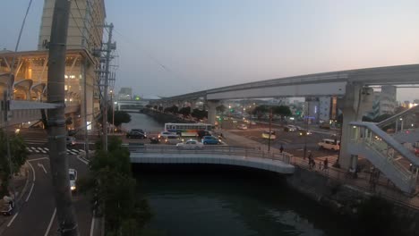 timelapse. naha city intersection in peak hour. trains travel along monorail line.