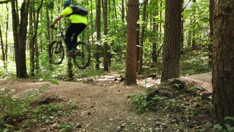 Springen-Sie-Mit-Dem-Mountainbike-Durch-Die-Lücke,-Während-Sie-Bergab-Fahren