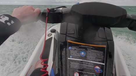 POV-shot-of-a-jet-ski-rider-getting-soaked-with-the-splashback-from-the-waves