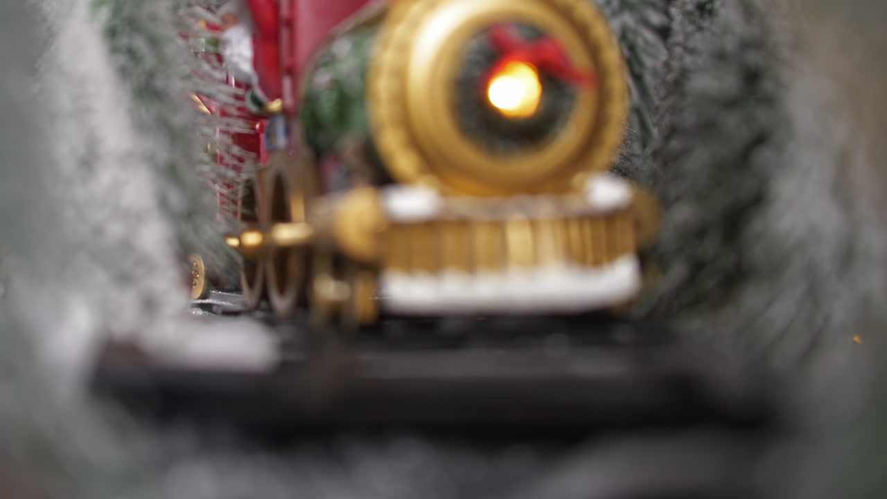 Christmas toy train makes an entrance toward the camera
