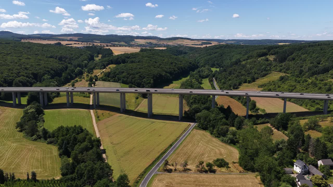 Bridge infrastructure highway, in the german eifel region. Motorway over crossing through a green valley. Germany. Aerial video