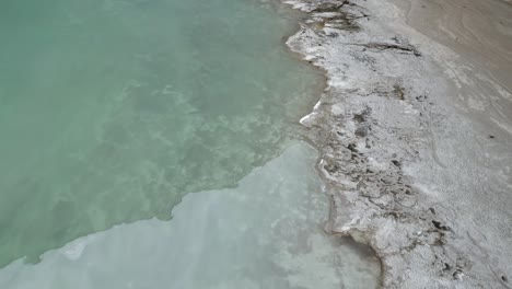 Aerial-drone-top-down-shot-over-frozen-lake-in-mountain-valley-in-Bolivia-at-daytime