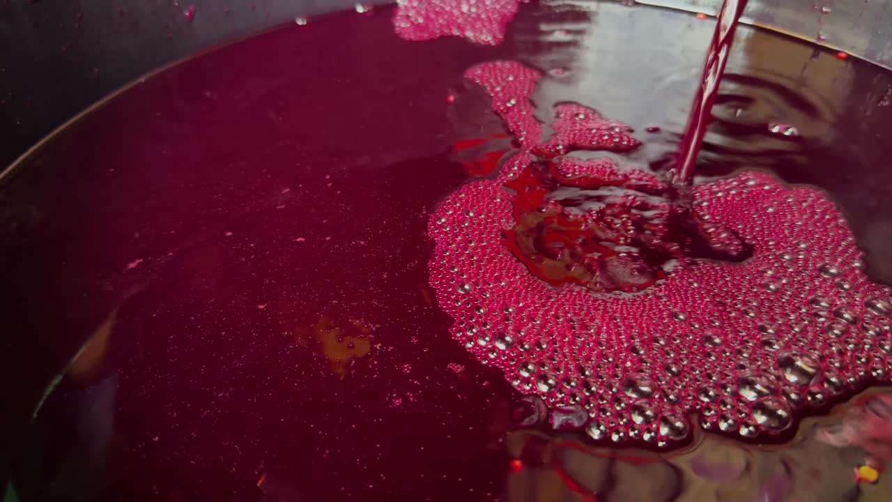 After the harvest, the Borraçal grapes are pressed and the blood-red juice flows into a barrel