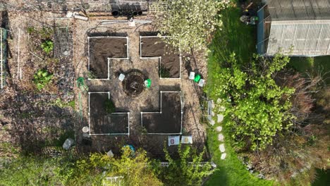 Top-down-aerial-shot-of-a-garden-in-Spring,-prior-to-the-vegetation-has-bloomed