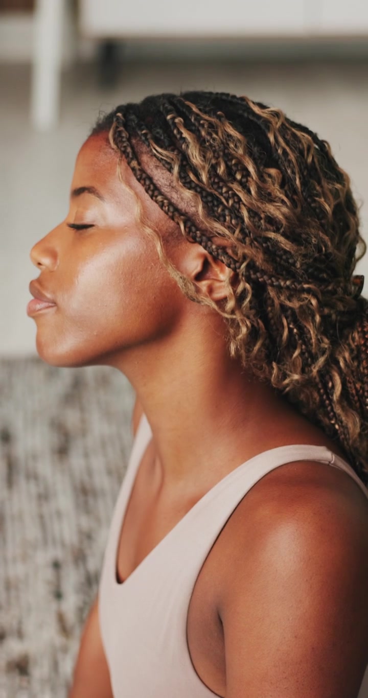 Young Woman Practicing Yoga and Meditation at Home