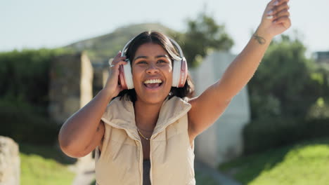 happy woman, headphones and dancing at park