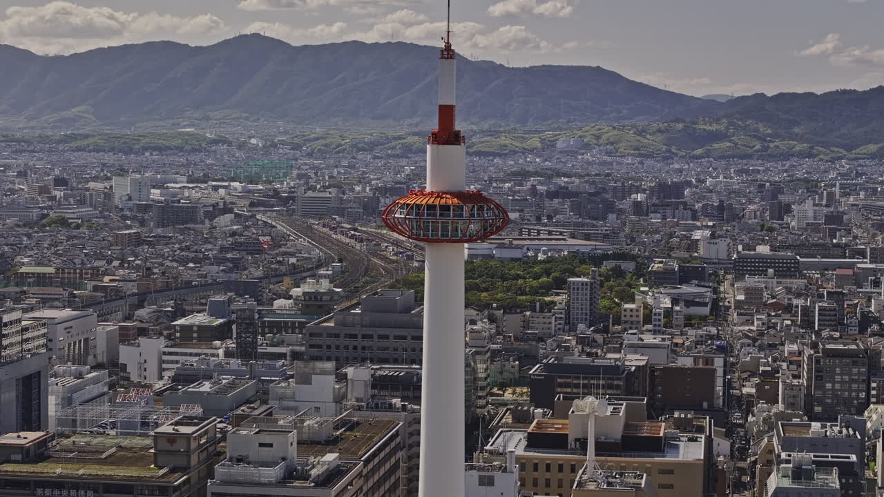 Kyoto Japan Aerial v77 zoomed flyover Kaminocho Higashishiokojicho capturing the landmark tower and Shimogyo ward cityscape against mountainous background - Shot with Mavic 3 Pro Cine - Oct 8th 2023
