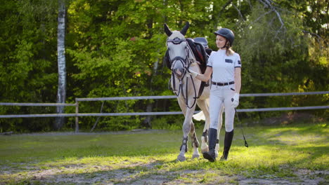 Girl-with-horse-on-the-walk-in-the-horse-club.-They-are-walking-together-in-nature-girl-leads-her-horse.