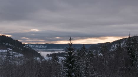 Weiße-Wolken,-Die-Sich-Im-Winter-über-Die-Bergkette-Und-Den-Wald-Bewegen