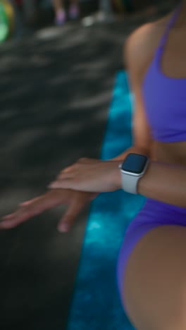 woman in activewear on an exercise mat, preparing for a workout