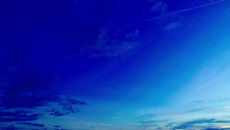 Drone-shot-looking-down-in-a-sweeping-pan-shot-against-a-dusk-sky-with-a-long-highway-with-vehicle-plying-upon