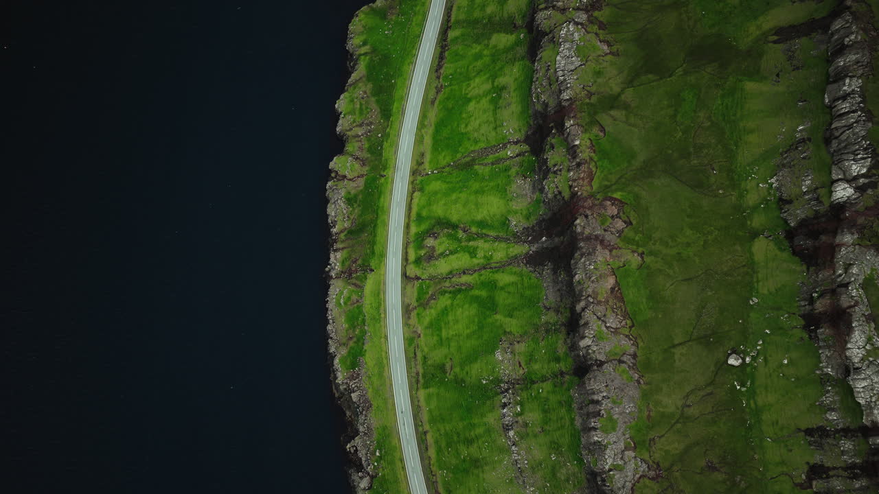 Aerial View of a Road Along Green Coastal Cliffs