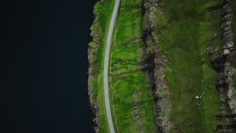 aerial view of a road along green coastal cliffs
