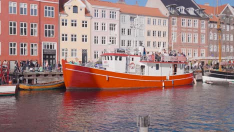 ship parked near historic nyhavn canal with colorful building exterior, denmark