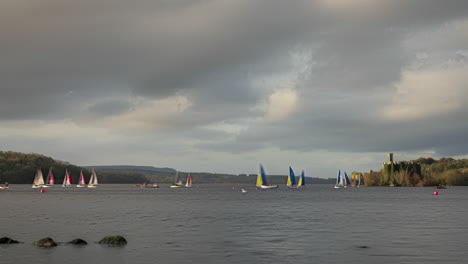 Timelapse-of-local-water-sport-yachting-boats-with-castle-ruin-in-distance-at-Lough-Key-in-county-Roscommon-in-Ireland-on-a-cloudy-day