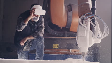 worker using vr headset with industrial robot and cnc machine