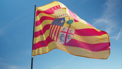 beautiful shot of the flag of huelva, spain during a medieval fair in huelva, spain in the morning