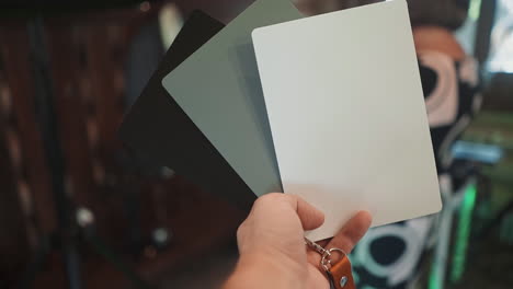 photographer uses cards to adjust camera in restaurant