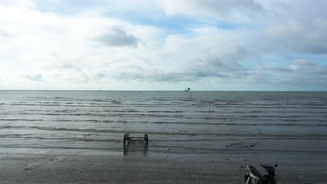 drone flying at low altitude out over beach