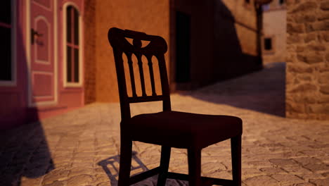 an old wooden chair sitting on a cobblestone street in an old city