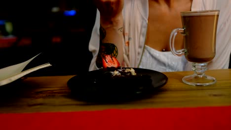 woman eating pastry in cafe 4k