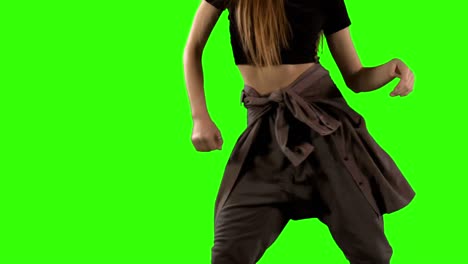 mid section of woman dancing against green screen background