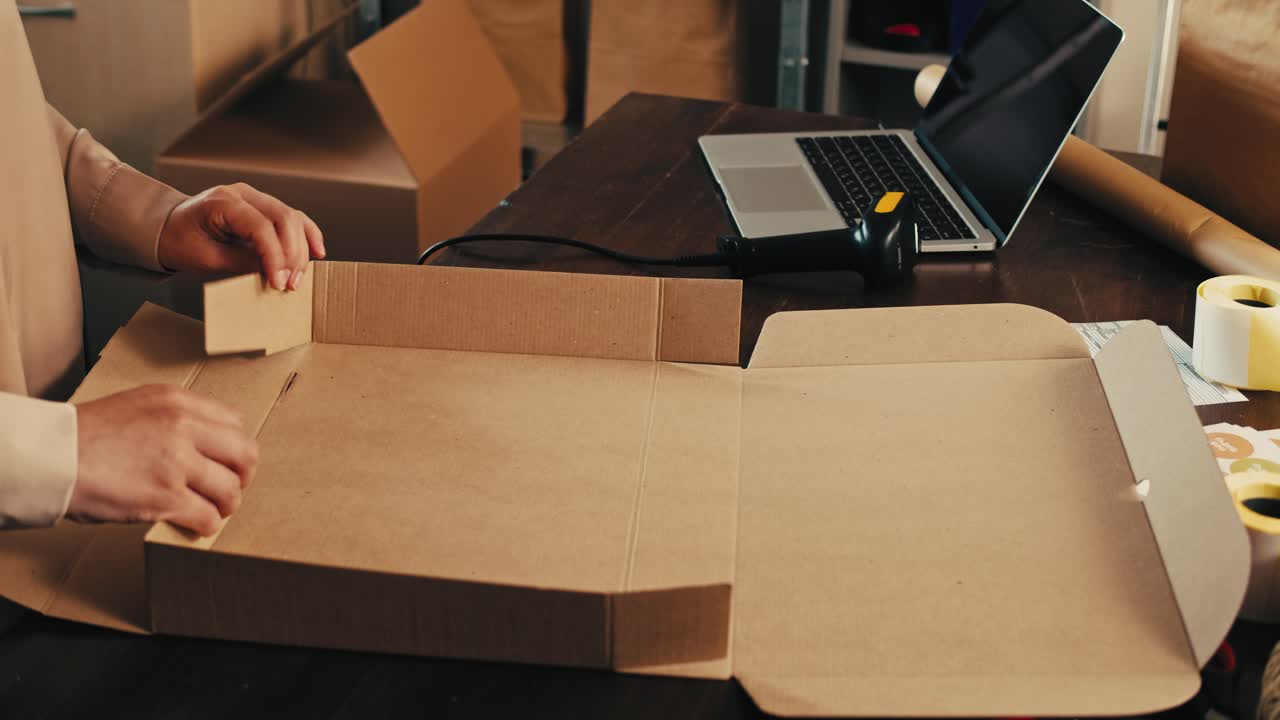 E-commerce storage shop, woman packing goods and clothes for second hand delivery market, dedicated Packaging and Shipping Workspace with Supplies and Technology for efficiency, online sales.