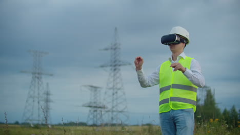 Retrato-De-Un-Hombre-Moderno-Del-Contralor-Del-Ingeniero-Que-Realiza-La-Inspección-A-Través-De-Gafas-De-Realidad-Virtual-Y-Un-Casco-Blanco-Vestido-De-Uniforme-Al-Fondo-De-Las-Torres-De-Poder.