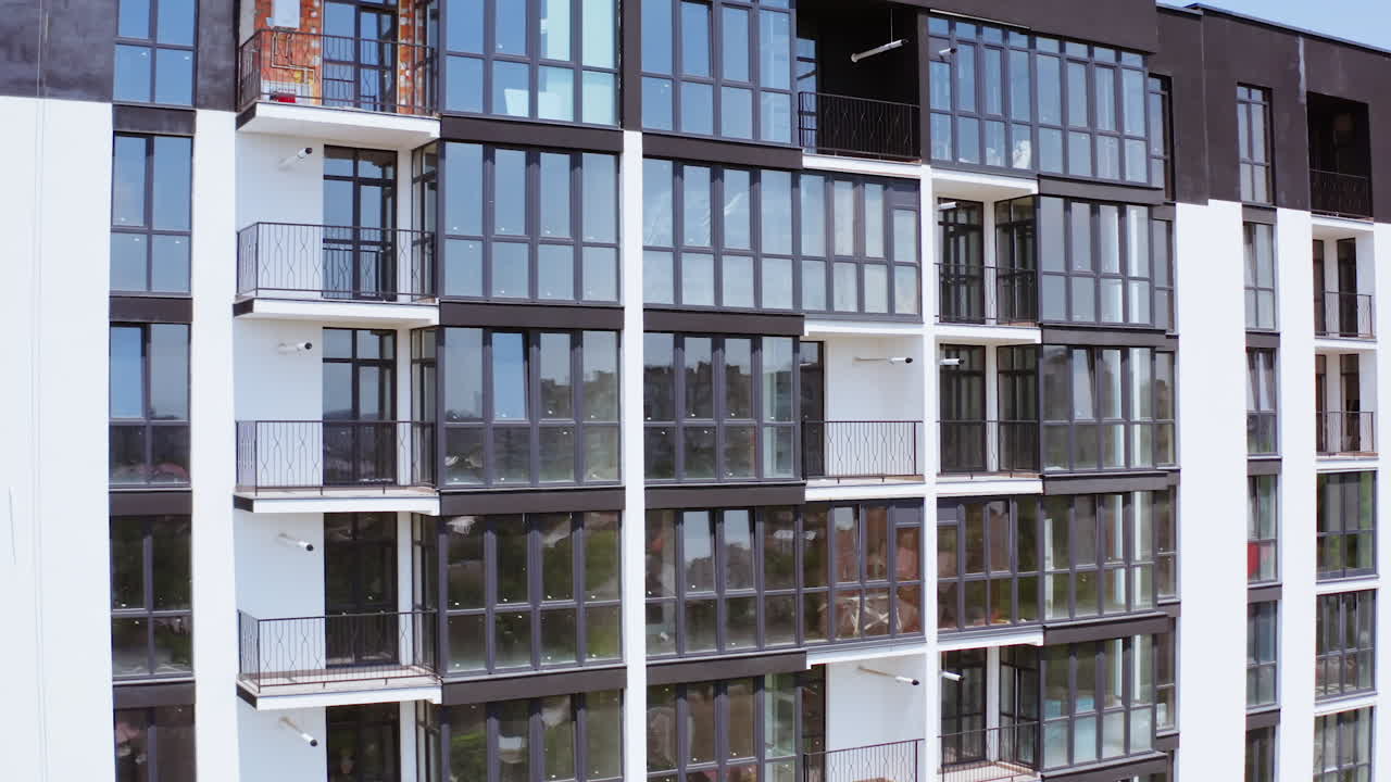 Drone view of apartment buildings. Aerial view of the facade of new residential complex in minimalist style