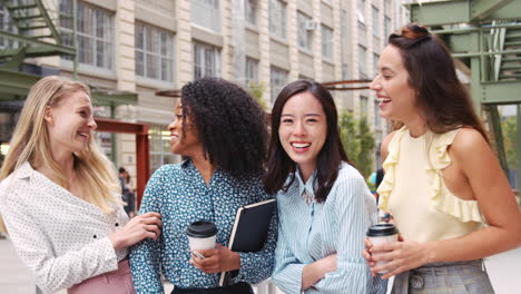 Female-work-friends-laughing-outside-their-workplace