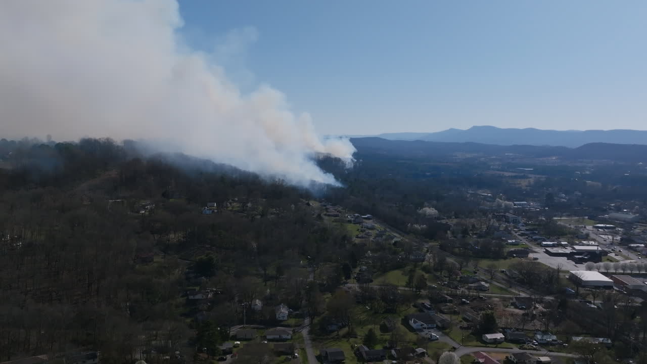 Aerial drone footage rotating around of a large forest fire in Rossville, Georgia.