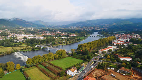 Stunning-aerial-4K-drone-footage-of-a-village---Ponte-de-Lima-and-its-two-bridges-crossing-over-the-Lima-River