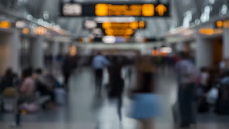 blurred view of a busy airport or train terminal with travelers