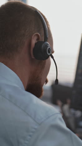 businessman wearing headset and working on computer