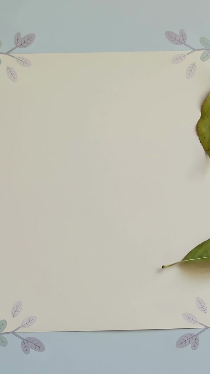 Vertical video: Entering from right, two leaves drifting onto floral-cornered sheet on mat, resting
