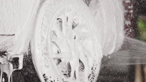 slow-motion car wheel and tire spa with spray foam soap