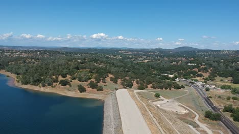 hover high above the shore of a big lake with a drone