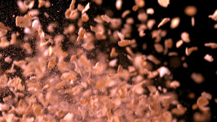 Oat flakes bouncing against black background