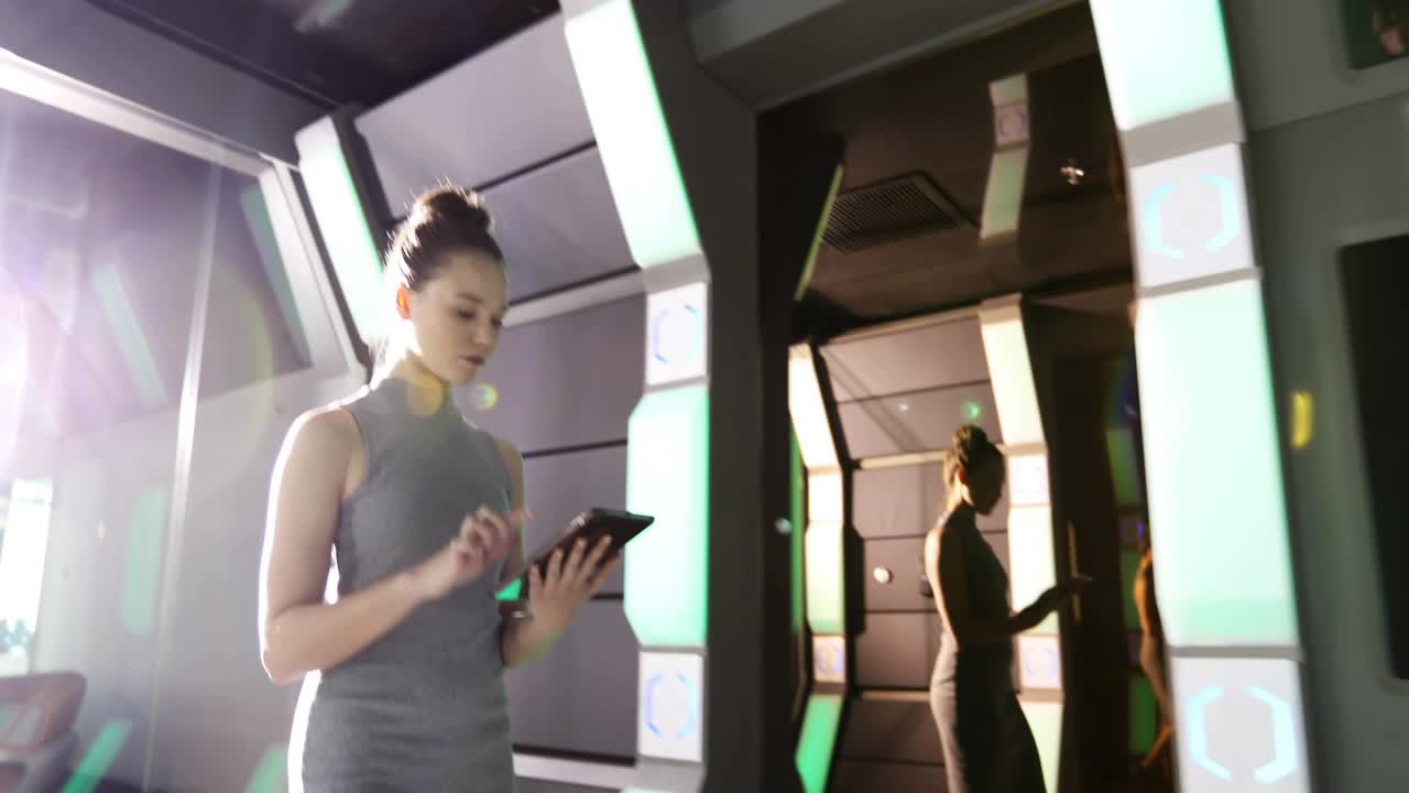 Woman tapping tablet to track social metrics in tech corridor HUD badges growing and engulfing her