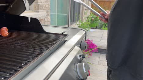 close-up slo-mo male chef hand opening outdoor barbecue to check food inside bbq