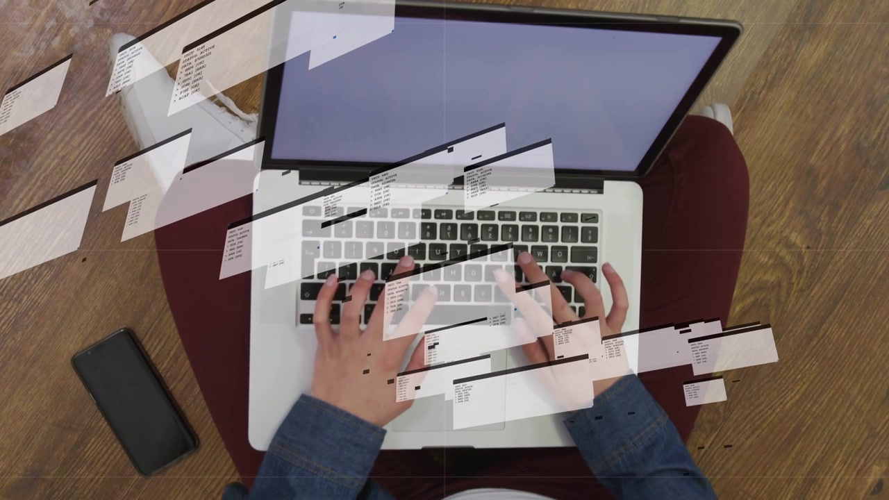 Woman on floor typing on laptop, causing animated UI overlays sliding over keyboard, testing tech