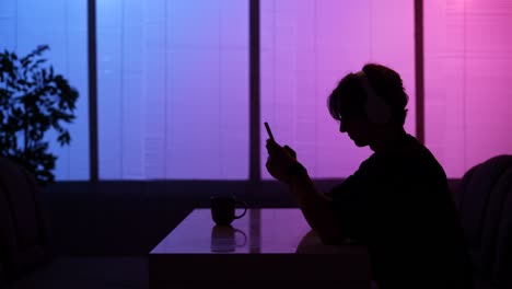 person listening to music and using smartphone at night
