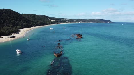 beautiful coastline of turquoise sea water, white sand, trees and shipwrecks