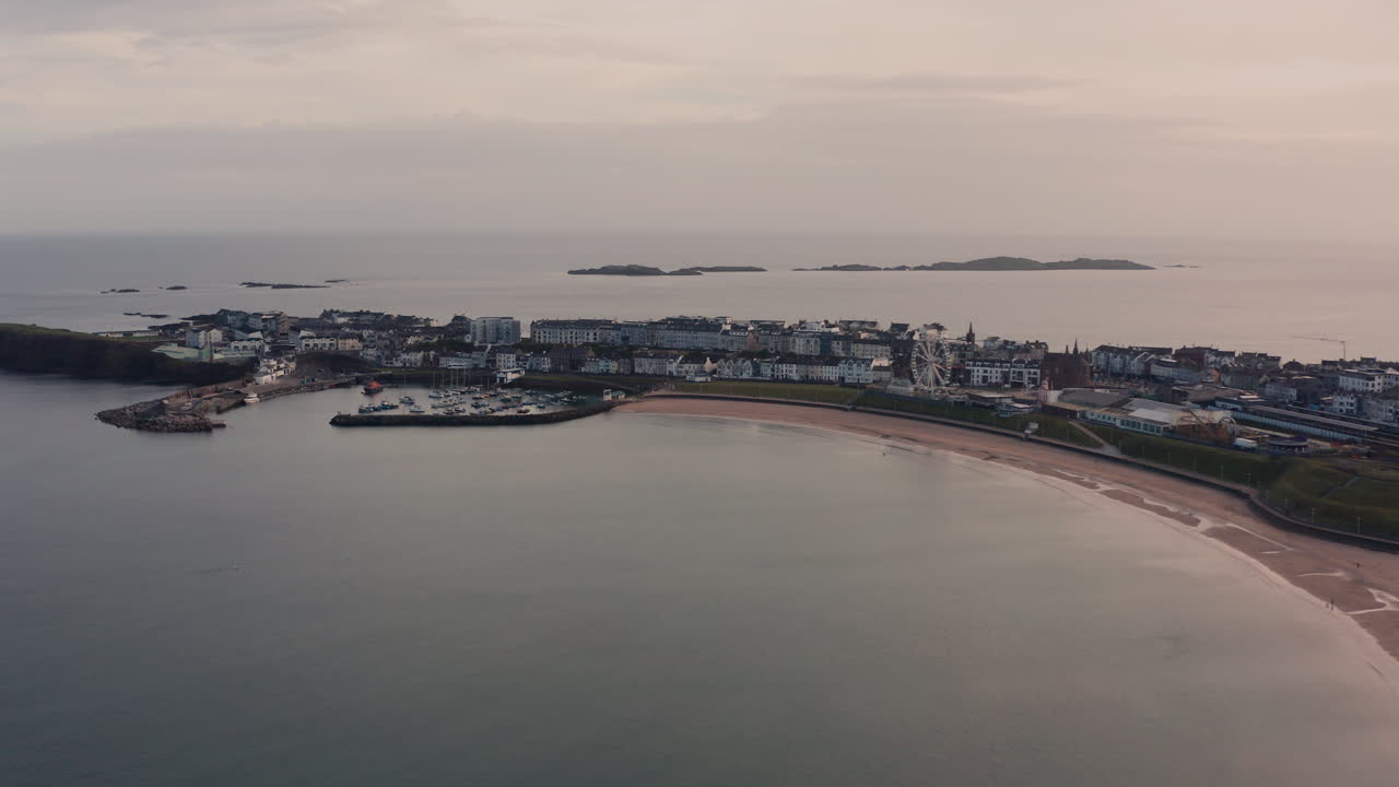 Aerial View of a Coastal Town with Harbor and Beach